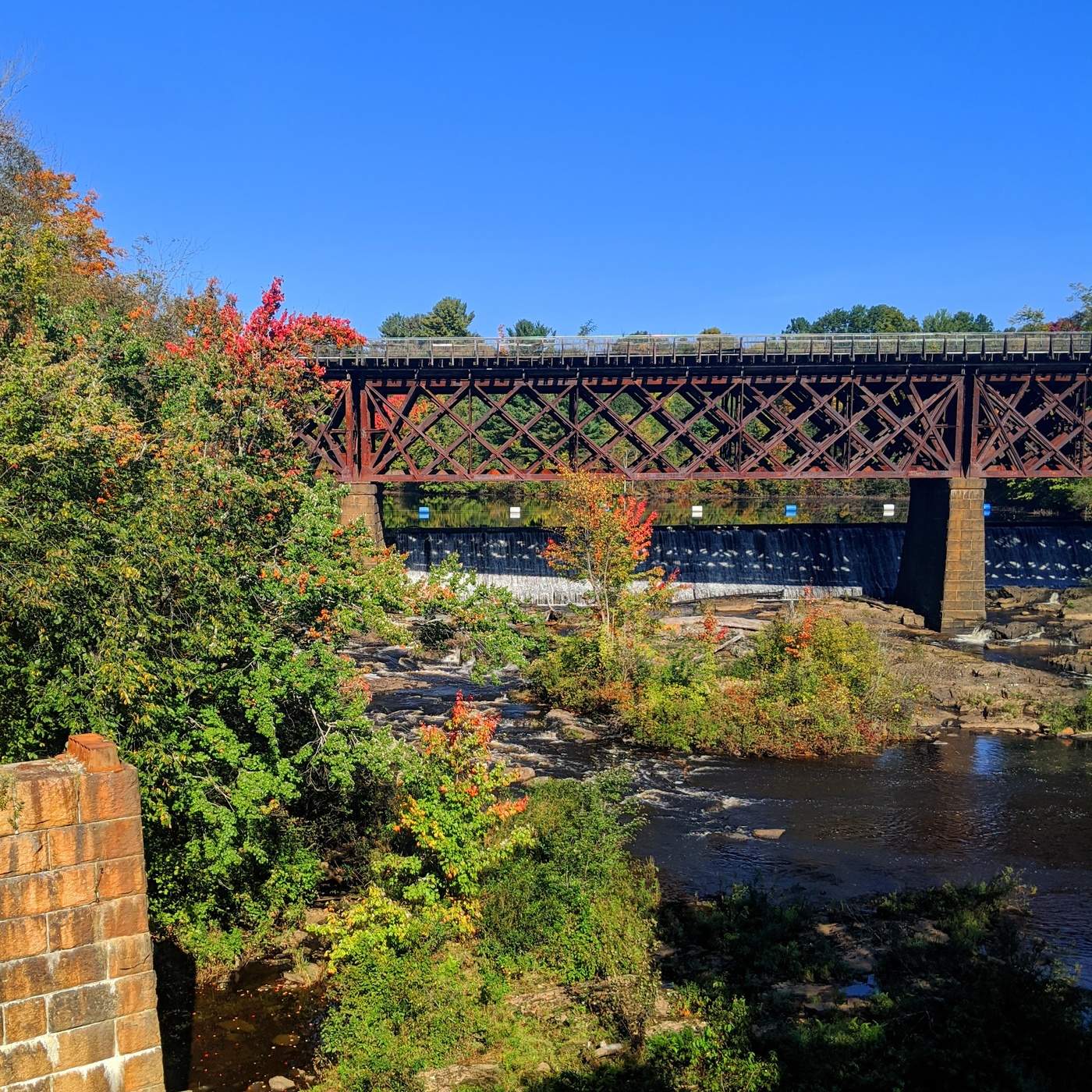 Created by you Beautiful contrast early fall foliage, by a train trestle over the Salmon Falls