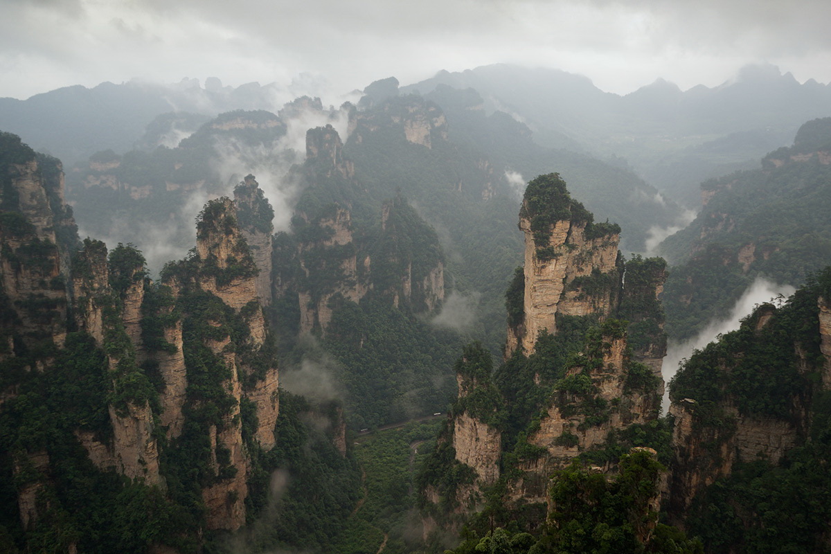 Felsen, Pinien, Wolken, Dunst