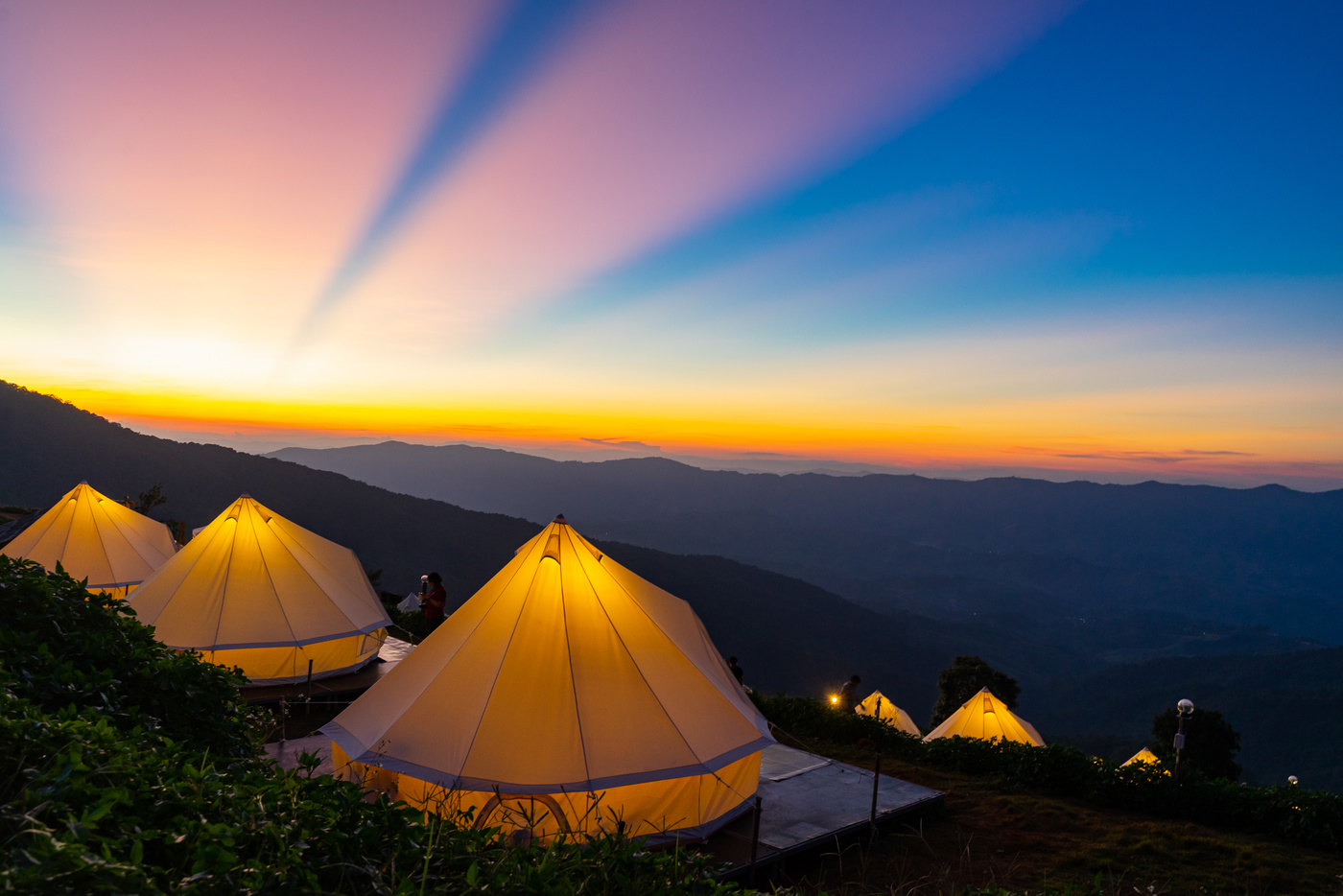 Camping with crepuscular rays after sunset background
